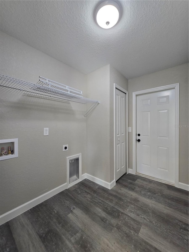 laundry room featuring dark wood-type flooring, baseboards, washer hookup, hookup for an electric dryer, and a textured ceiling