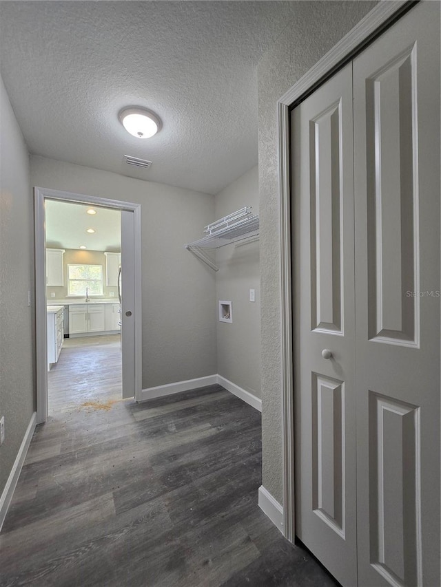 laundry area with visible vents, washer hookup, laundry area, wood finished floors, and a textured ceiling