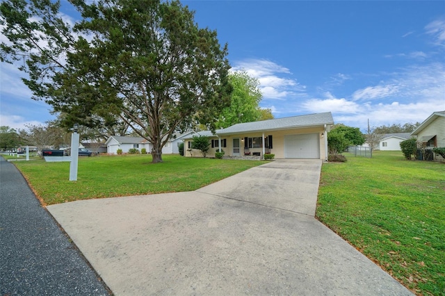 ranch-style home with a front lawn, an attached garage, and driveway