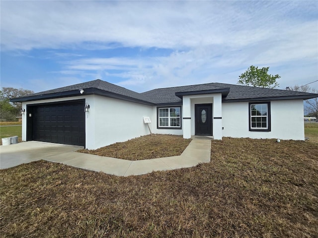 view of front of home featuring stucco siding, a front yard, concrete driveway, and an attached garage