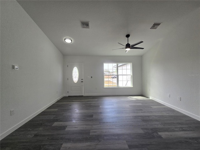 foyer featuring visible vents, ceiling fan, baseboards, and dark wood-style flooring