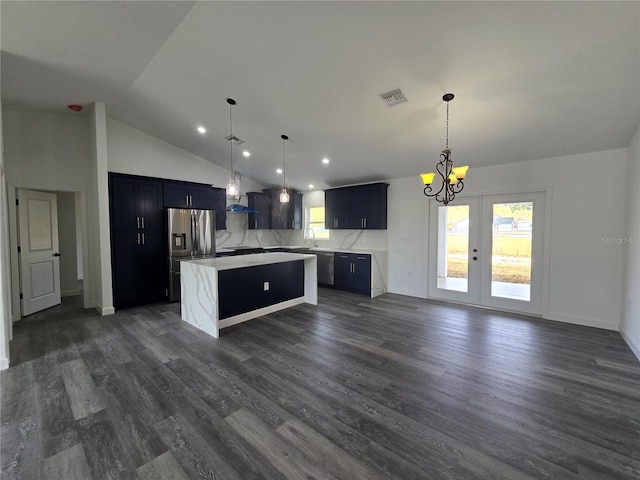 kitchen with dark wood-style floors, visible vents, a center island, and light countertops