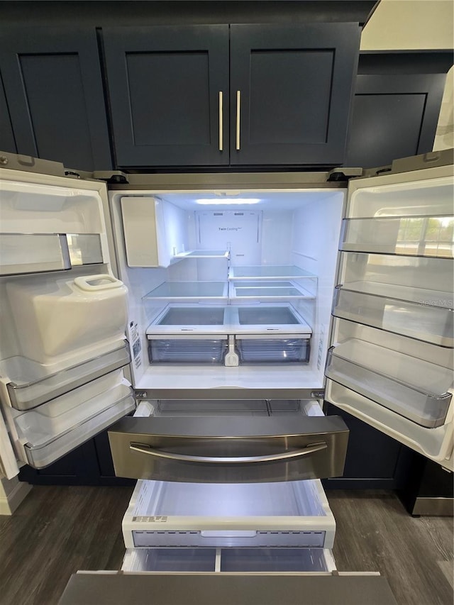 details featuring dark wood-style floors and fridge