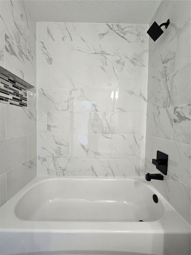 full bath featuring a textured ceiling