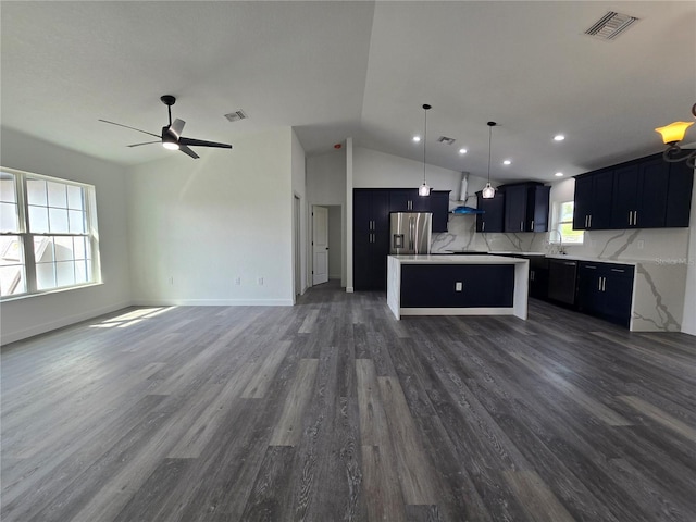 kitchen with a sink, visible vents, open floor plan, and stainless steel fridge with ice dispenser