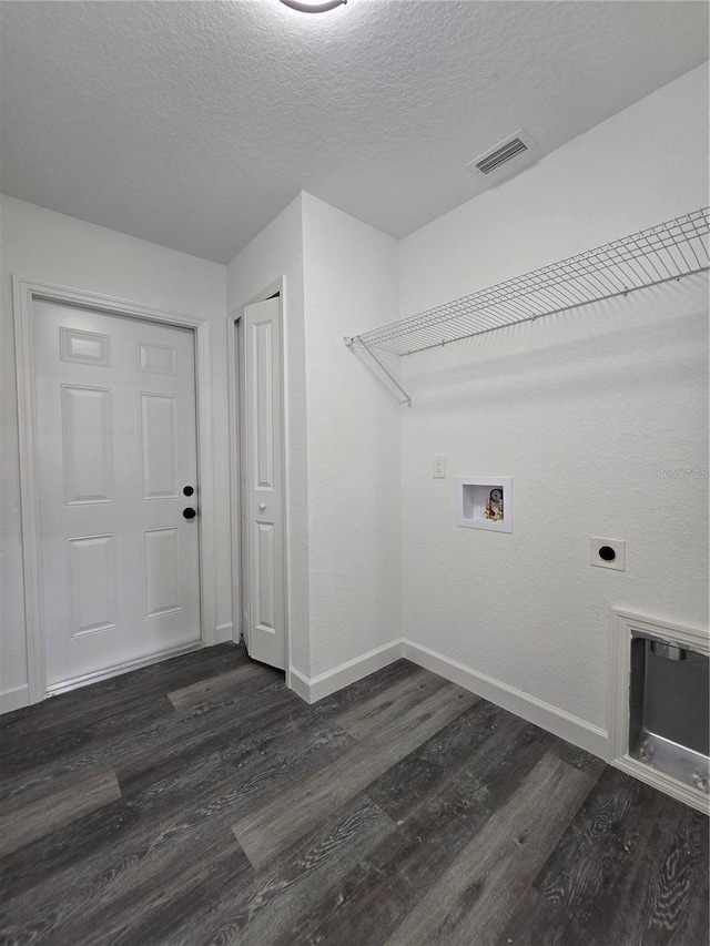 clothes washing area featuring hookup for a washing machine, baseboards, visible vents, dark wood-style flooring, and electric dryer hookup