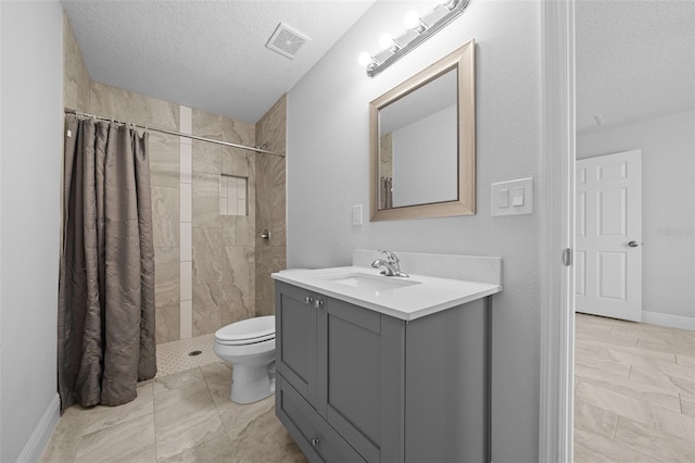 full bathroom featuring vanity, visible vents, tiled shower, a textured ceiling, and toilet