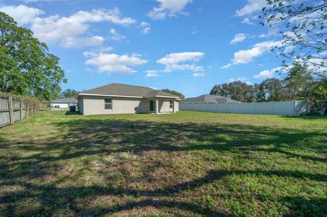 view of yard with a fenced backyard