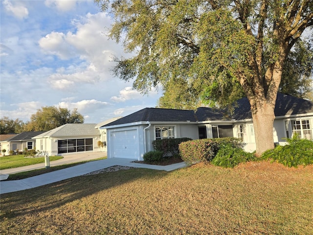 ranch-style house with a garage, driveway, a front lawn, and stucco siding