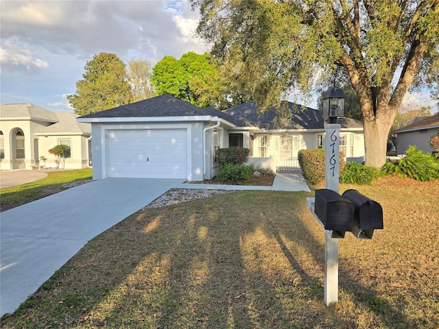 single story home featuring a garage, a front yard, driveway, and stucco siding