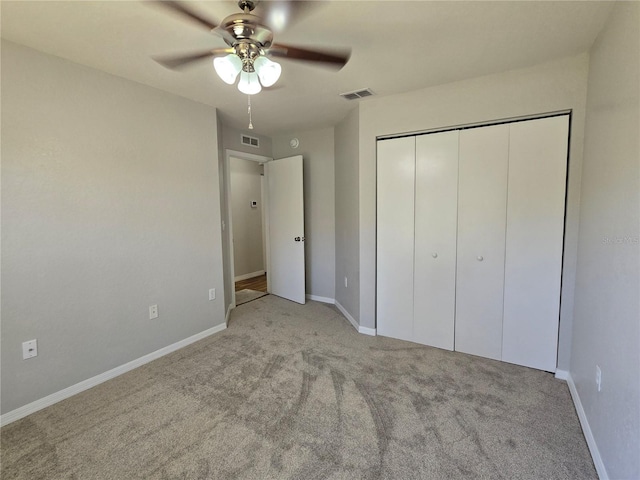 unfurnished bedroom featuring a closet, visible vents, carpet flooring, and baseboards