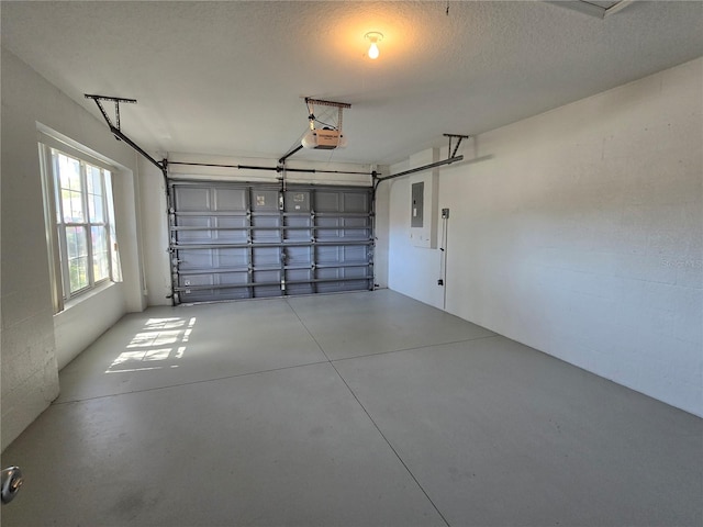 garage with electric panel and a garage door opener