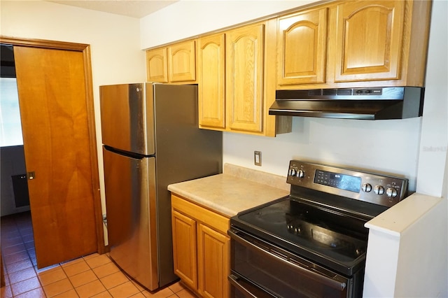 kitchen with under cabinet range hood, light countertops, freestanding refrigerator, and range with two ovens