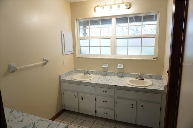 full bath with tile patterned floors, double vanity, and a sink