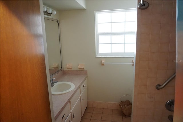 bathroom featuring tile patterned flooring, vanity, and baseboards