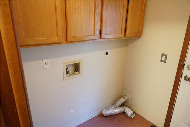 laundry area featuring tile patterned flooring, baseboards, hookup for a washing machine, cabinet space, and electric dryer hookup