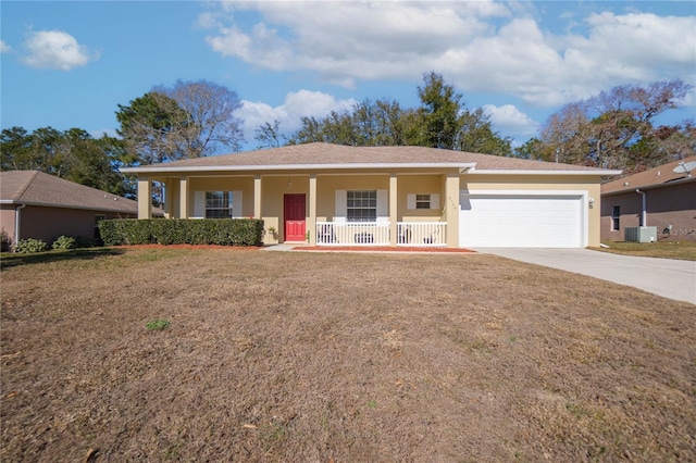 ranch-style house with a front yard, a porch, an attached garage, stucco siding, and concrete driveway