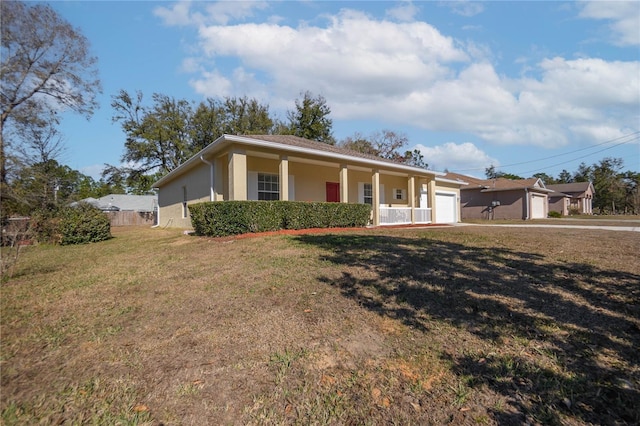 ranch-style home with a garage, fence, a front yard, and stucco siding