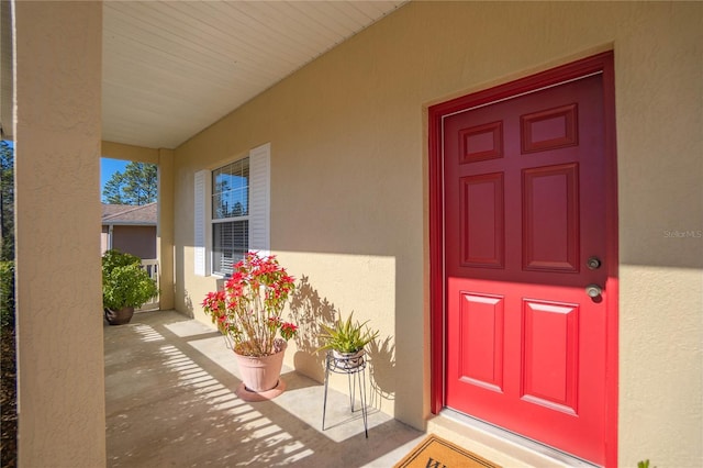 doorway to property with stucco siding