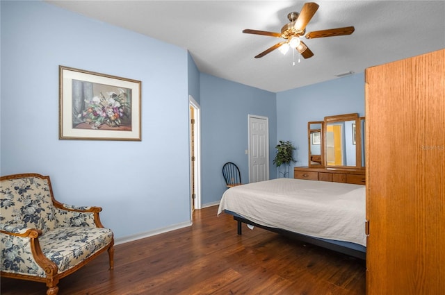 bedroom featuring visible vents, ceiling fan, baseboards, and wood finished floors