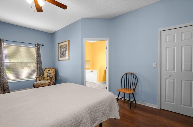 bedroom with ceiling fan, baseboards, wood finished floors, a textured ceiling, and ensuite bath