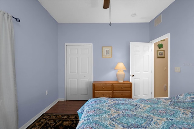 bedroom with visible vents, a ceiling fan, a closet, baseboards, and dark wood-style flooring