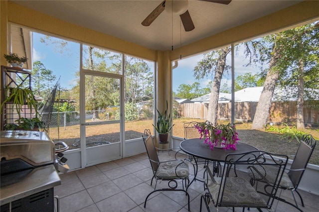 sunroom / solarium featuring ceiling fan