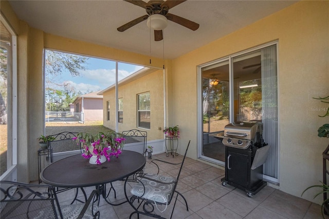 sunroom featuring a ceiling fan