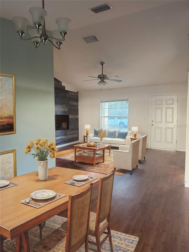 dining room with visible vents, wood finished floors, and ceiling fan with notable chandelier