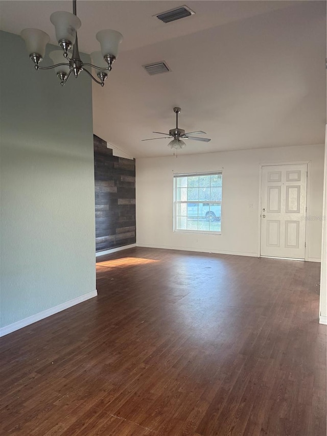 unfurnished room featuring ceiling fan with notable chandelier, wood finished floors, and visible vents