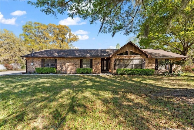 view of front of house with brick siding and a front yard