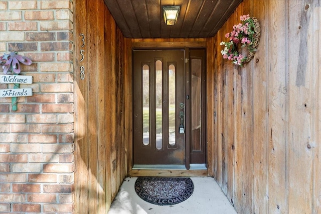 doorway to property with brick siding