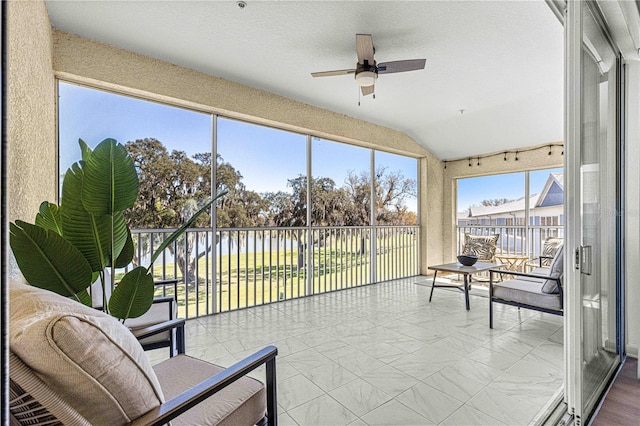 sunroom with vaulted ceiling and ceiling fan