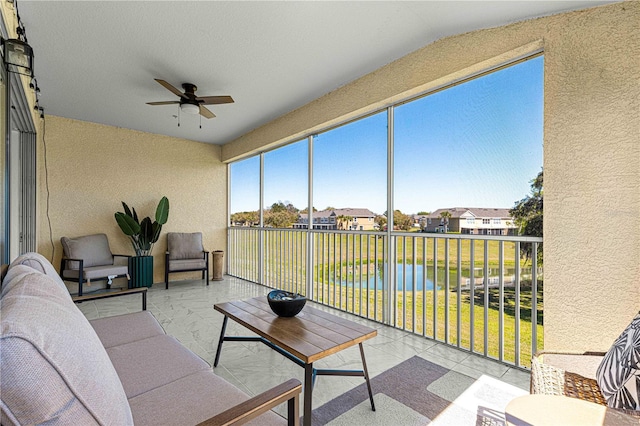 sunroom / solarium featuring a residential view and ceiling fan