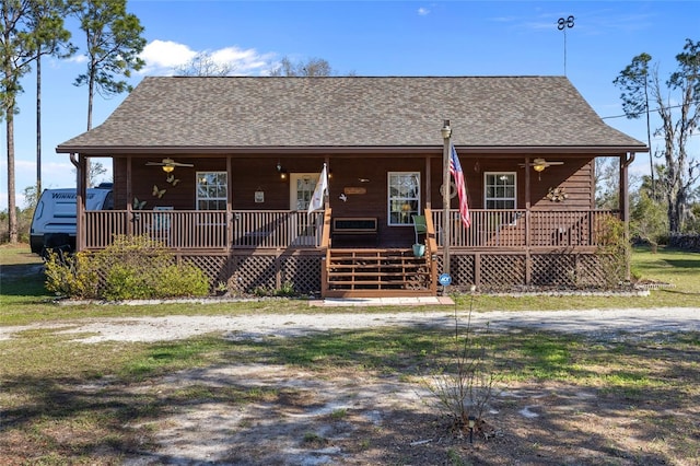 view of front of home with ceiling fan, a porch, and a shingled roof