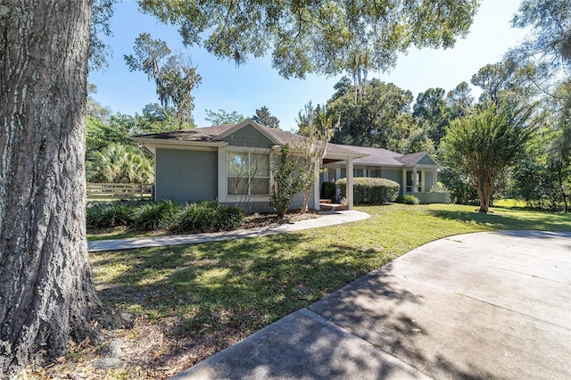 ranch-style home featuring a front yard and brick siding