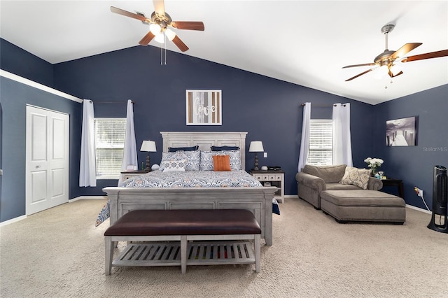 carpeted bedroom with lofted ceiling, multiple windows, and baseboards