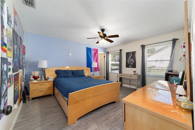 bedroom featuring visible vents, ceiling fan, and wood finished floors