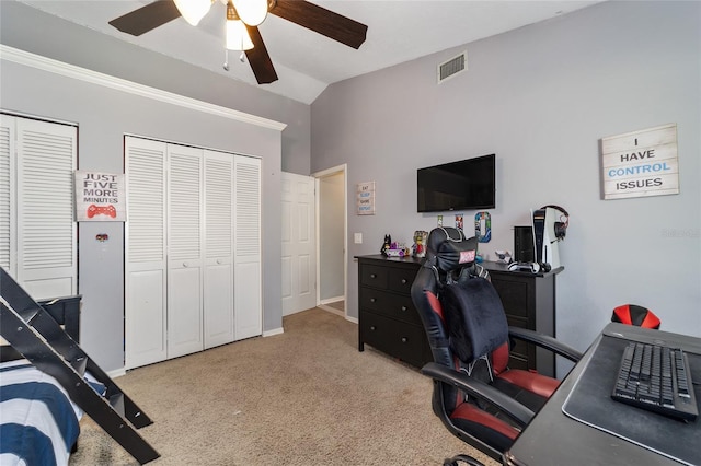 carpeted home office featuring visible vents, baseboards, a ceiling fan, and vaulted ceiling