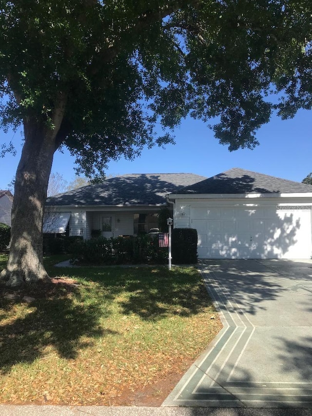 single story home with an attached garage, driveway, and a front yard