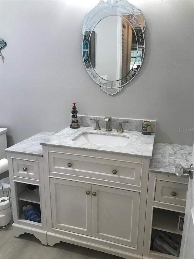 bathroom featuring toilet and vanity