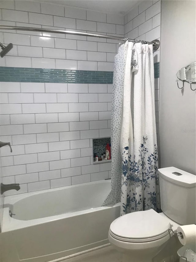 bathroom with toilet and shower / bath combo