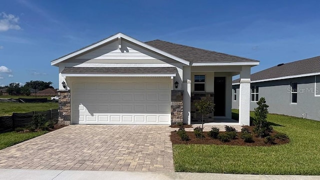 4040 NW 44th Cir, Ocala, FL 34482 - single story home featuring decorative driveway, a front lawn, stone siding, and an attached garage