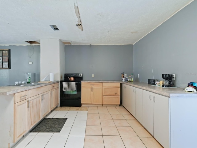 kitchen with light brown cabinets, a sink, black / electric stove, a peninsula, and light tile patterned floors