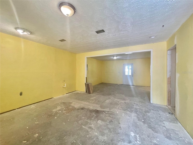 interior space with visible vents and a textured ceiling