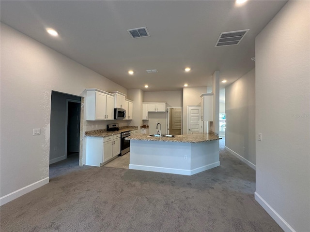 kitchen featuring visible vents, white cabinets, appliances with stainless steel finishes, and a sink