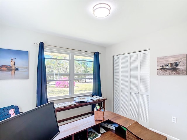 office area featuring baseboards and wood finished floors