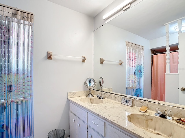 bathroom with a sink and double vanity