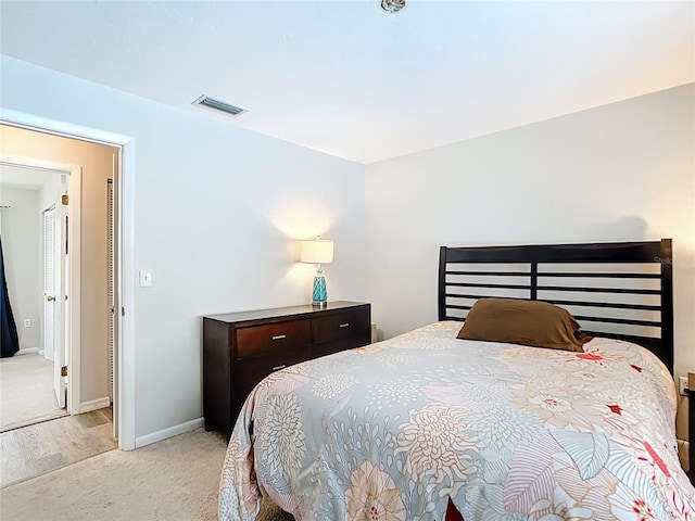 carpeted bedroom with baseboards and visible vents