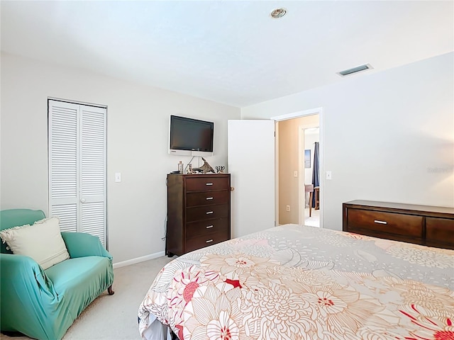 bedroom featuring light colored carpet, visible vents, a closet, and baseboards